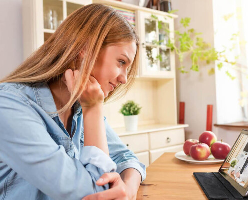 A woman listens to her therapist over video chat. This could represent the the convenience of telepsychiatry in New York, NY. Learn more about online adult psychiatry in New York, NY by contacting an online psychiatrist in New York, NY today!