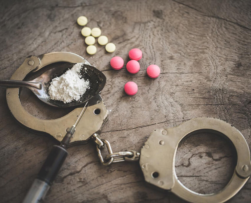 A close up of cuffs, pills, a syringe, and a powder in a spoon. A psychiatrist in New York, NY can offer treatment for opioid withdrawal in New York, NY. Learn how we can offer online opioid treatment in New York, NY and other services today.