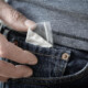 A close up of a person pulling a bag out of their pocket. This could represent a struggle with drug addiction an addiction psychiatrist in New York, NY can help you overcome. Learn more about behavioral addiction treatment in New York, NY by searching “addiction specialist NYC” today.