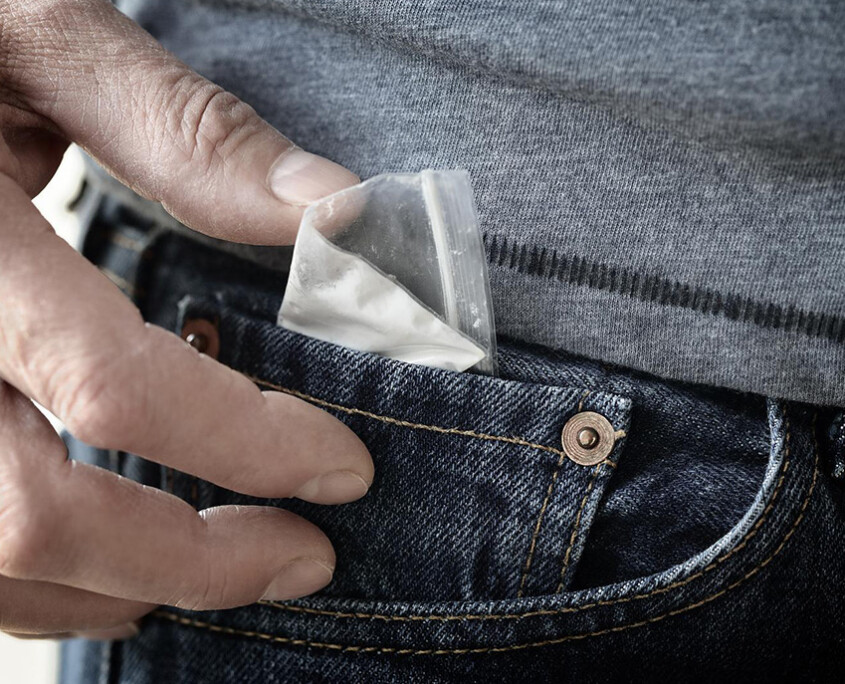 A close up of a person pulling a bag out of their pocket. This could represent a struggle with drug addiction an addiction psychiatrist in New York, NY can help you overcome. Learn more about behavioral addiction treatment in New York, NY by searching “addiction specialist NYC” today.