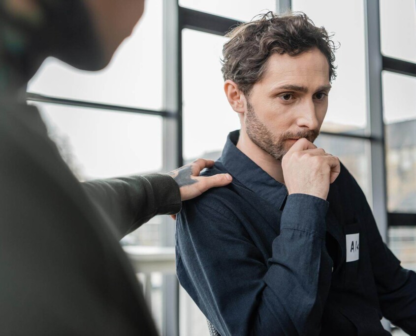 A person placed a hand on the shoulder of a man with a concerned expression. This could represent the support that outpatient addiction treatment in New York, NY can offer. Learn how to offer support for loved ones of those affected by addiction in New York, NY by searching for a drug addiction therapist in New York, NY today.