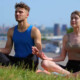 A couple smiles while practicing yoga. Learn how an adult psychiatrist in New York, NY can offer support with addiction treatment in New York, NY and other services today. Contact an online psychiatrist in New York, NY to learn more.