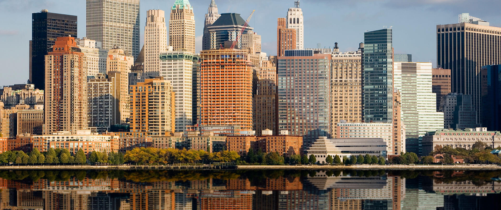 Lower Manhattan reflected in the calm waters of the Hudson River. An addiction psychiatrist in New York, NY can offer support with support for families of addicts in New York, NY. Learn more about online addiction treatment in New York, NY by contacting a drug addiction therapist in New York, NY today! 10022