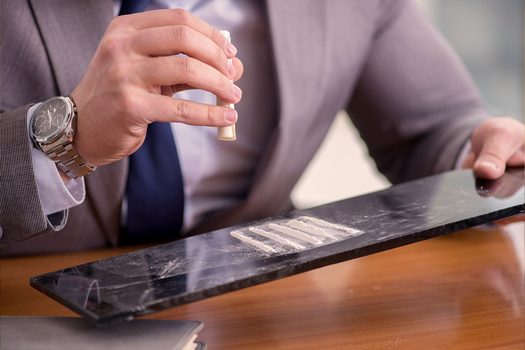 A close up a business man and lines of coke for Addiction Treatment Expert. Cocaine addiction treatment in New York, NY can offer you support. Contact a cocaine addiction therapist in New York, NY to learn more about cocaine addiction recovery in New York, NY. 10022