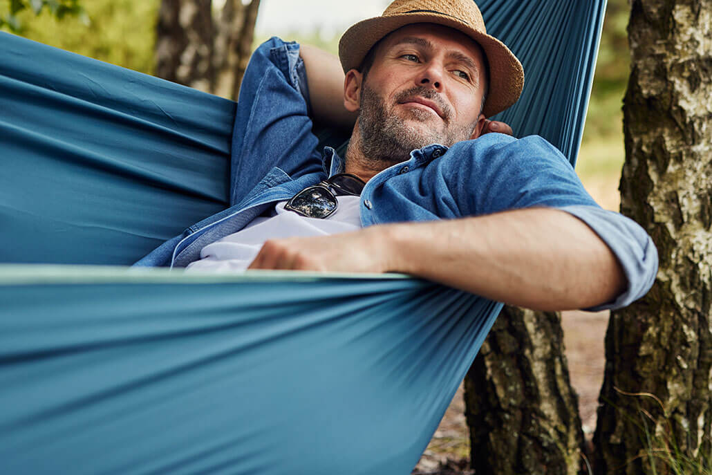 Relaxed and happy man in a hammock