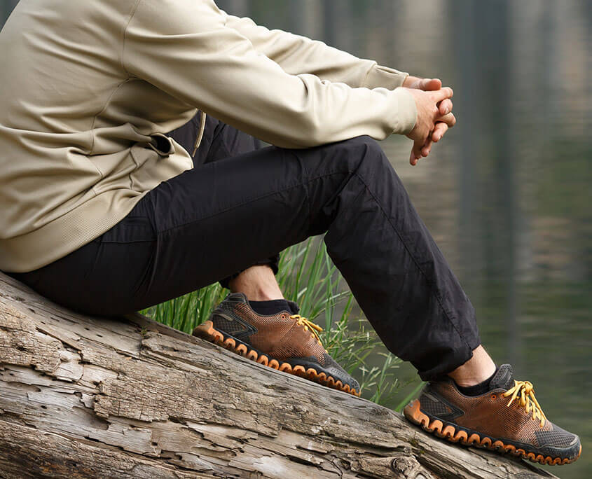 Man sitting on a log by a quiet lake. Meth addiction treatment in New York, NY can offer support with meth abuse. Contact a substance abuse psychiatrist in New York, NY to learn more today! 10022