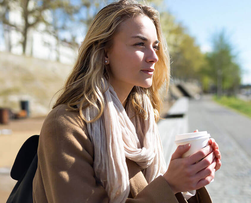 Contemplative woman sits on a sidewalk bench. Prescription drug addiction treatment in New York, NY can offer support. Contact a drug addiction therapist to learn more about narcotic addiction treatment in New York, NY. 10022