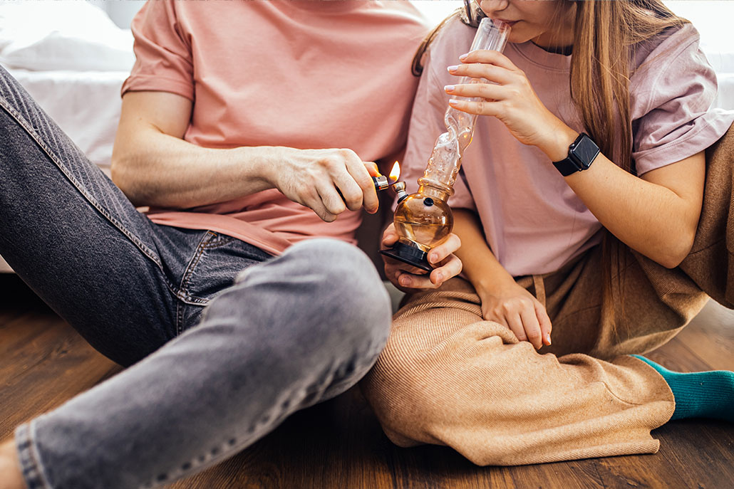 A couple sharing marijuana. This could represent the negative effects of marijuana abuse in New York, NY. Learn more about marijuana treatment in New York, NY by contacting a substance abuse psychiatrist in New York, NY. 10022