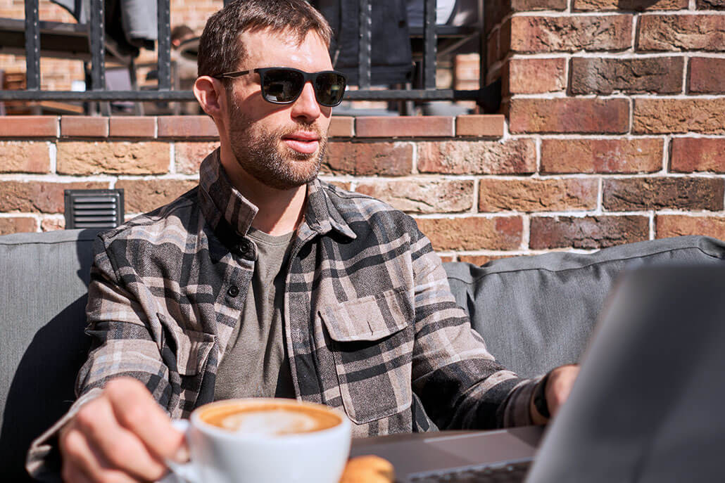 Sober man drinking coffee at an outdoor cafe. Opioid use disorder treatment in New York, NY can help prevent overdosing. Contact Stephen Gilman for treatment for opioid withdrawal in New York, NY today!