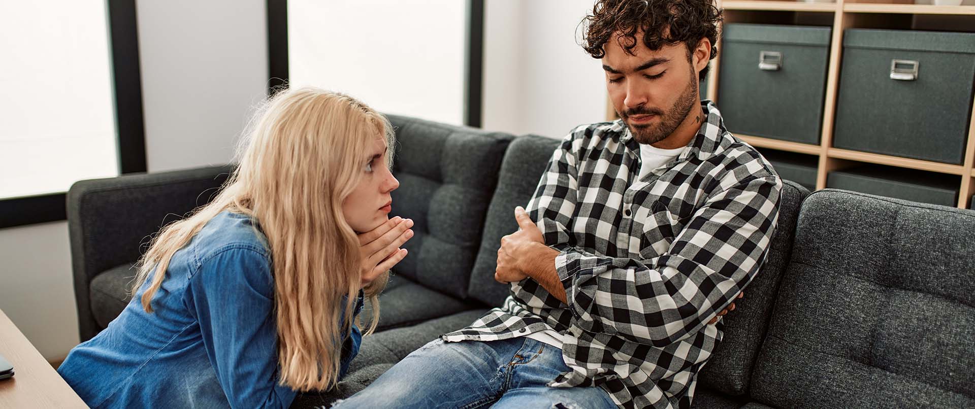 A couple appear to argue with one another on a couch. This could represent how a psychiatrist can offer support for families of addicts in New York, NY. Contact us to learn more about support for friends of addicts in New York, NY today. 10022