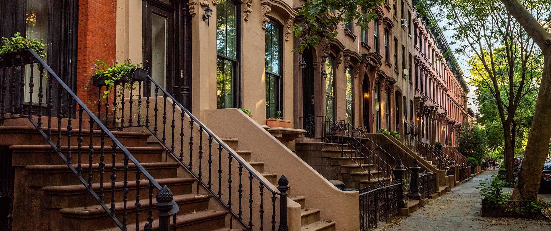 Brownstones on a tree lined street in New York City | Psychiatrist and addiction treatment expert, Stephen Gilman MD, offers treatment solutions for general psychiatry and addiction in NYC, NY