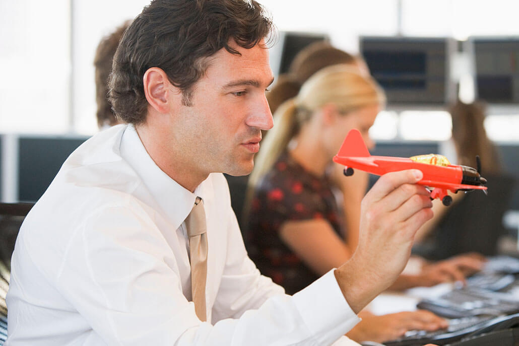 business mans plays with toy airplane. This could represent the concentration issues ADHD treatment in New York, NY can offer support with. Learn more about treatment for ADHD in New York, NY today. 10022