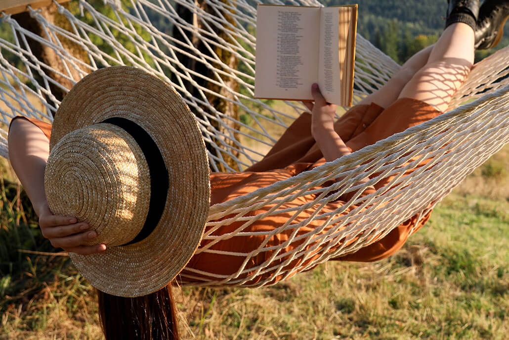 woman in hammock reading a book. Adult psychiatry in New York, NY can help you address what is keeping you from peace. Contact an adult psychiatrist in New York, NY today! 10022