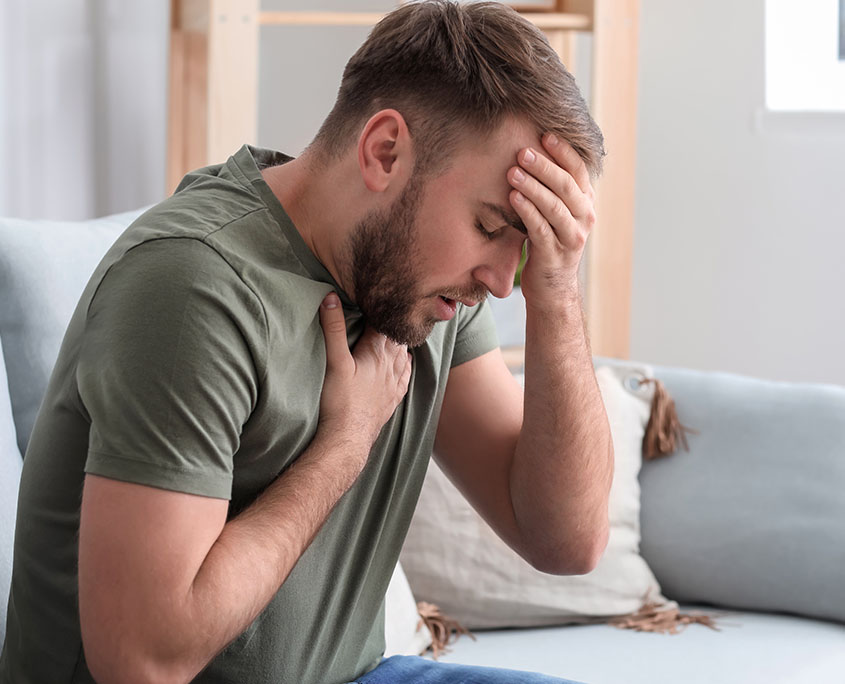 Distressed man having a panic attack. This could represent the trauma PTSD treatment in New York, NY can address. Learn more about PTSD treatment in NYC, Manhattan by contacting a PTSD therapist in New York, NY. 10022