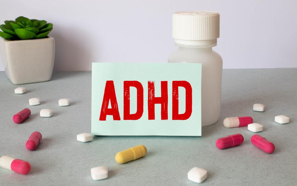A close up of a pill bottle and a note reading “ADHD”. Learn more about alcohol addiction treatment in New York, NY and the support an online psychiatrist in New York, NY can offer from the comfort of home.
