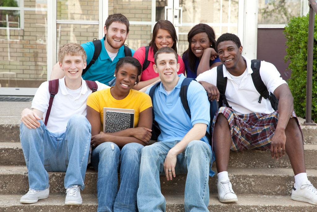 A group of college friends sit together while smiling for the camera. This could represent the support a psychiatrist for young adults in New York, NY can offer. Learn more about substance abuse treatment in New York, NY and other services by contacting a psychiatrist in New York, NY today. 