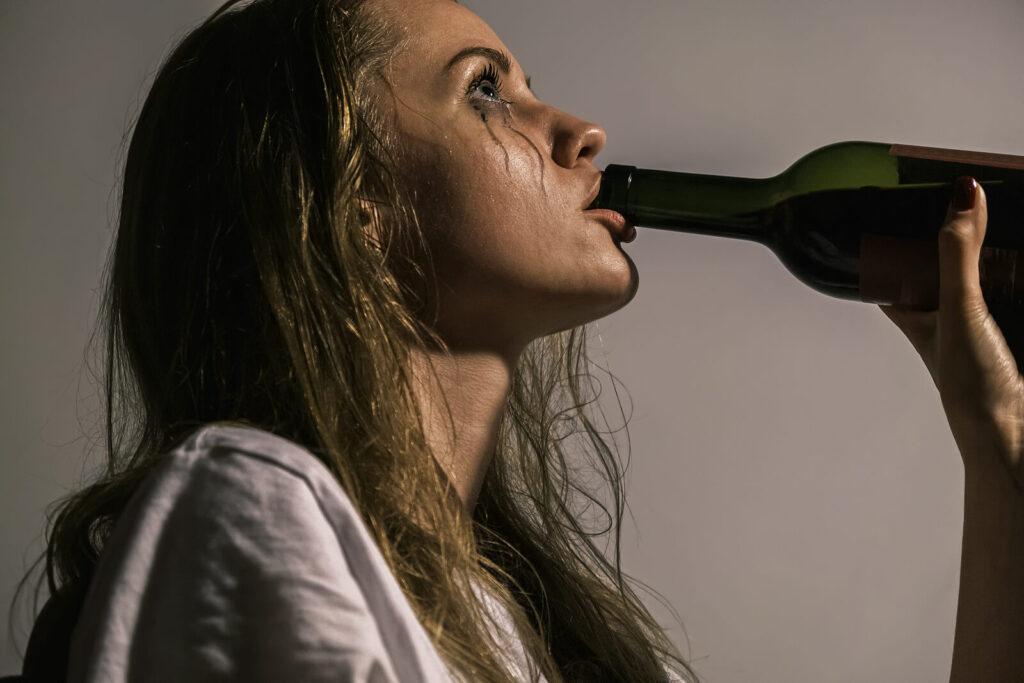 A close up of a women drinking from a bottle with tears streaming down her face. Learn how alcohol treatment in New York, NY can offer support for families of alcoholics in New York, NY. An addiction therapist can tell you more about alcohol addiction treatment in New York, NY today. 