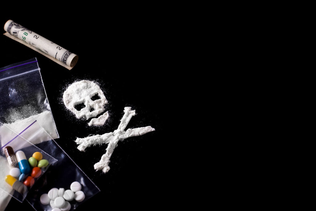 An image of a white powder in the shape of a skull and crossbones with bags of pills resting nearby. This could represent the dangers of opioids that opioid addiction treatment in New York, NY can address. Learn more by contacting an online psychiatrist in New York, NY 10022. A therapist in NYC, Manhattan can offer treatment for opioid withdrawal in New York, NY and more. 