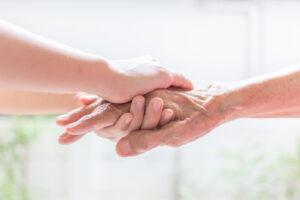 A close up of a person holding the hand of a loved one. This could represent the support that outpatient addiction treatment in New York, NY can offer. Learn how to offer support for loved ones of those affected by addiction in New York, NY by searching for a drug addiction therapist in New York, NY today. 
