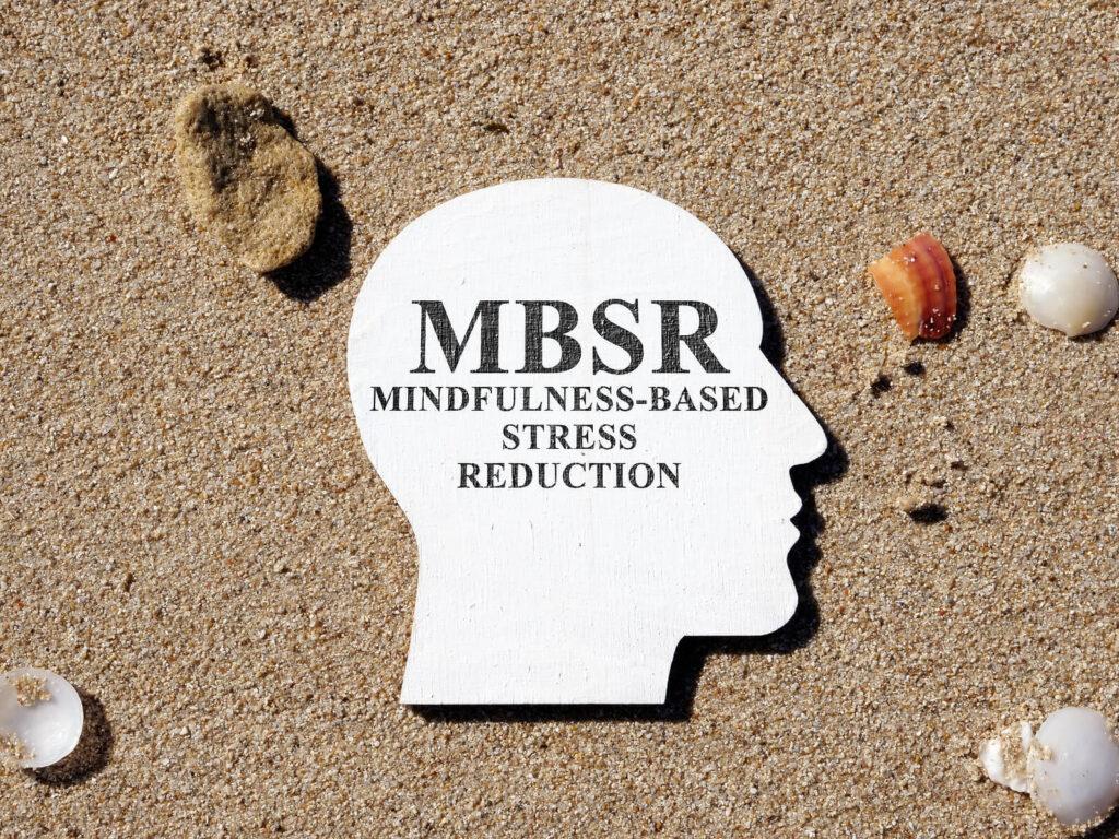 A profile of a face with the text MBSR Mindfulsness-based stress reduction on a sandy beach. Learn how an adult psychiatrist in New York, NY can offer addiction treatment in New York, NY and other services including addiction treatment in New York, NY.
