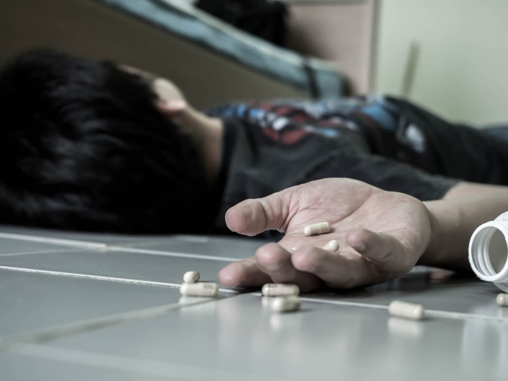 A person lays on their back as pills roll out of their hand. Opioid addiction treatment in New York, NY can help you avoid overdoses. Contact an online psychiatrist in New York, NY 10022. For online opioid treatment in New York, NY and other services. 
