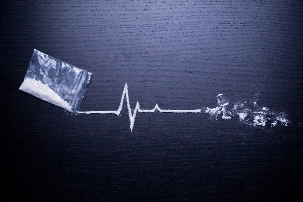 A bag of powder with a trail of powder resembling a heart monitor. A psychiatrist in New York, NY can offer support with treatment for cocaine addiction in New York, NY and other services. Learn more about how cocaine addiction treatment in New York, NY can offer support with cocaine addiction recovery in New York, NY.