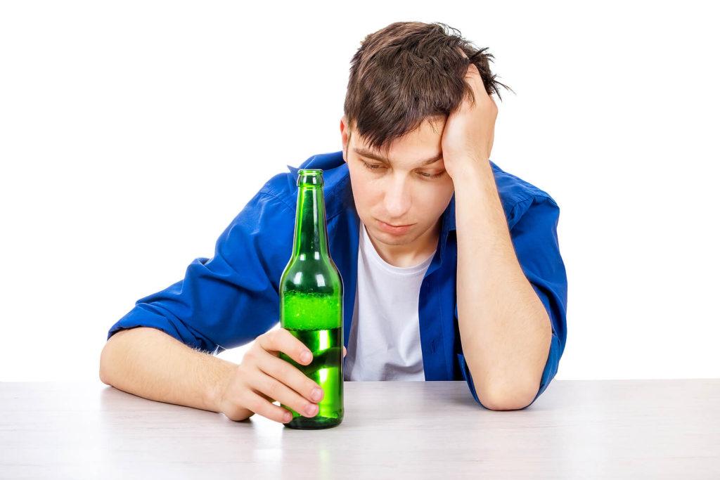 A sad man looks somberly at a bottle with a bubbly beverage. Alcohol addiction treatment in New York, NY can offer alcohol addiction help in New York, NY and a number of other services. Telepsychiatry in New York, NY can offer support from the comfort of home. 