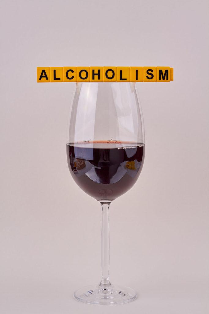 A photo of a wine glass with the word alcoholism resting above it. Learn how alcohol addiction treatment in New York, NY can help you overcome addiction by using telepsychiatry in New York, NY. Contact Addiction Treatment Expert Stephen Gilman for alcohol addiction help in New York, NY. 
