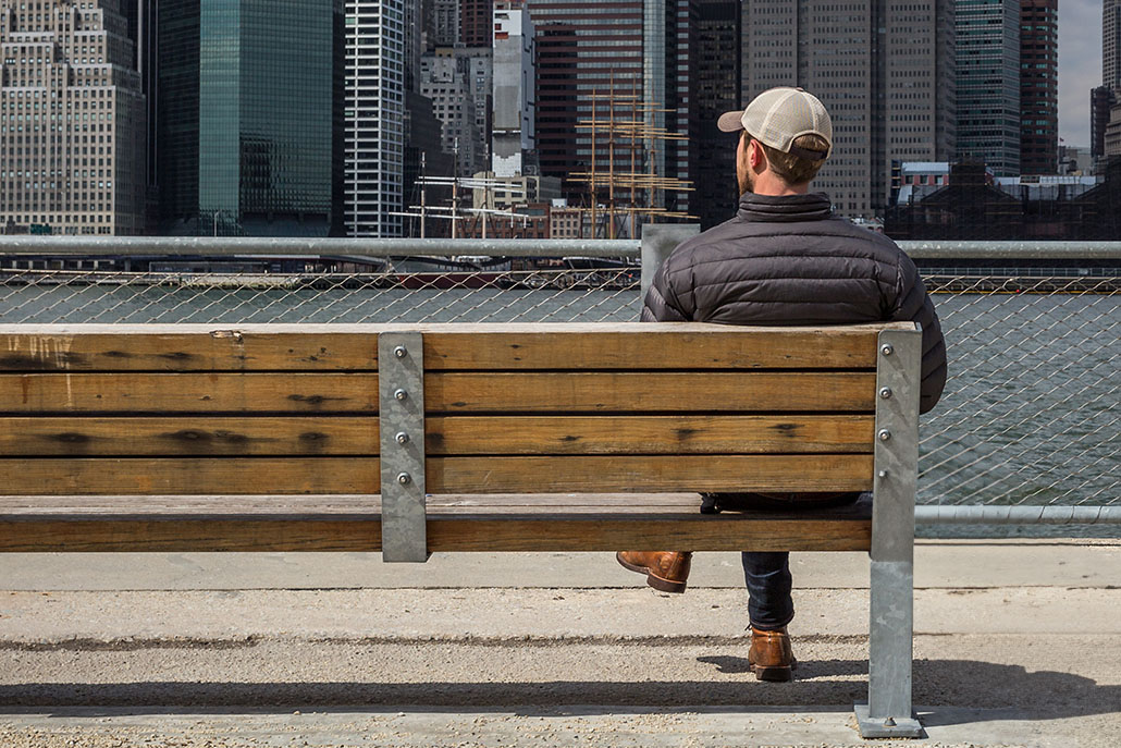 contemplative man sits alone on a bench | An addiction therapist in New York, NY can help you overcome addiction with treatment in New York, NY. Learn more by contacting an adult psychiatrist in New York, NY today! 10022